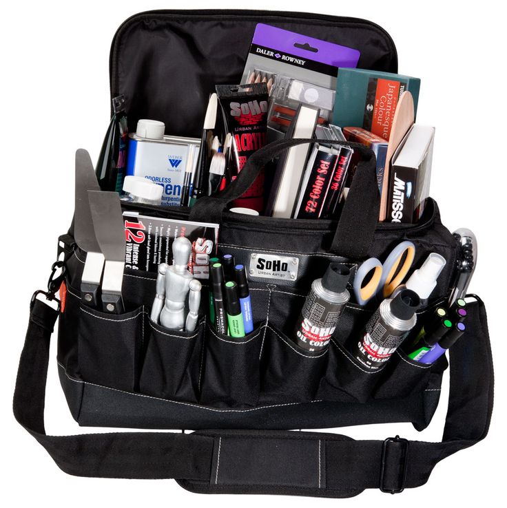 a black bag filled with lots of items and writing utensils on top of a white background