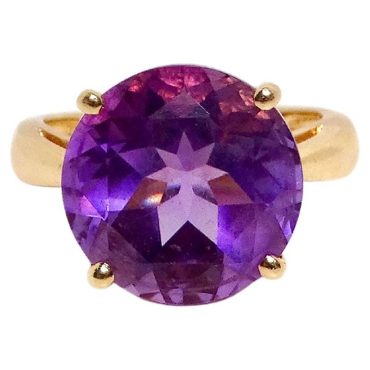 Embrace timeless elegance with the Amethyst 14k Yellow Gold Solitaire Ring, a stunning piece that radiates sophistication. This exquisite ring features a captivating amethyst stone, prominently set on a delicate thin band that beautifully accentuates its vibrant purple hue. The simplicity of the design allows the rich color of the amethyst to take center stage, making it a perfect accessory for both everyday wear and special occasions. This versatile ring can be styled elegantly with other designer items such as a dainty pair of diamond stud earrings from Tiffany & Co. or a delicate bracelet by Cartier. Pair it with a classic silk blouse from Chanel for an effortlessly chic and polished ensemble that embodies refined taste. Measurements: Size: 5.5 Weight: 4.35g Yellow Gold Solitaire Ring, Cushion Diamond Ring, Pear Shaped Ring, Yellow Gold Solitaire, Gold Solitaire Ring, Geometric Ring, Vibrant Purple, Modern Ring, Tourmaline Ring