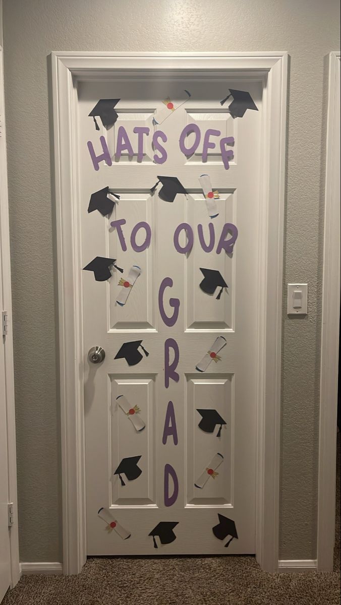 a door decorated with graduation caps and tassels that says hat's off to our graduate