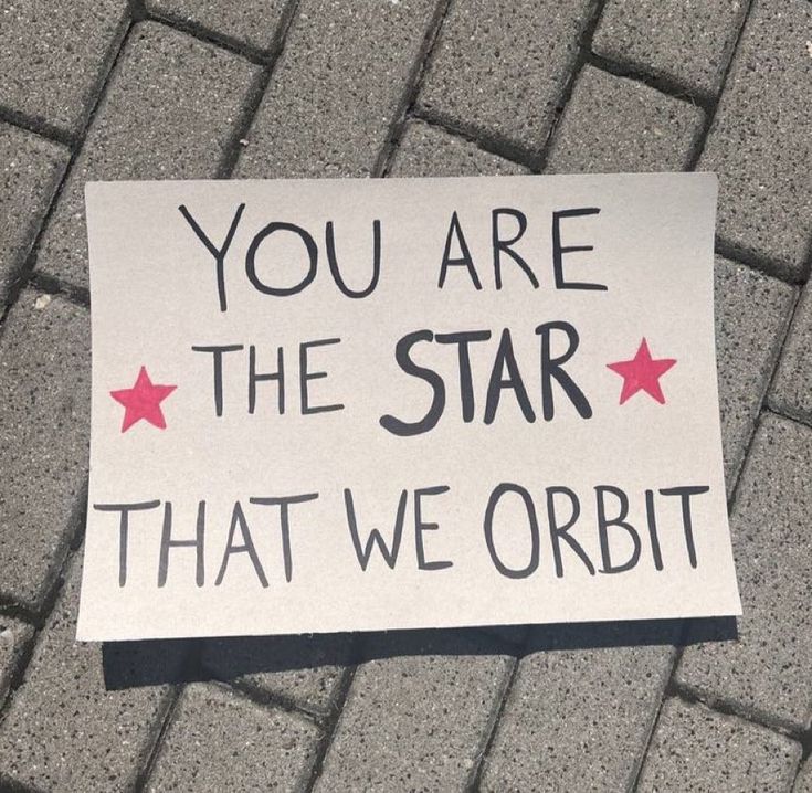 a sign on the ground that says, you are the star that we orbitt