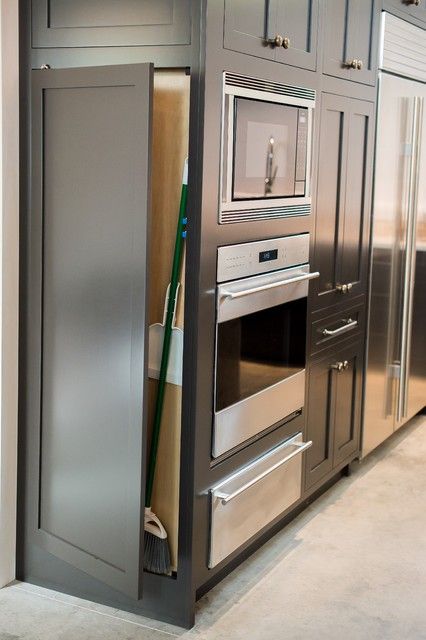 an oven built into the side of a cabinet in a kitchen with stainless steel appliances