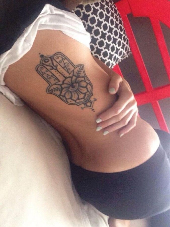 a woman with a tattoo on her stomach