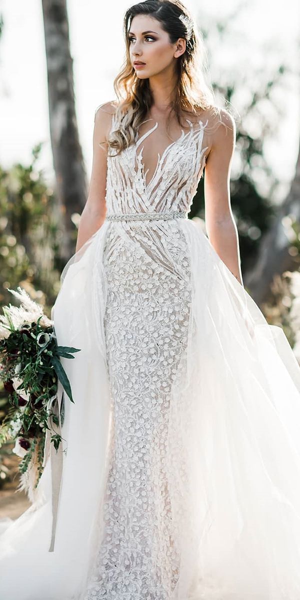 a woman in a wedding dress holding a bouquet