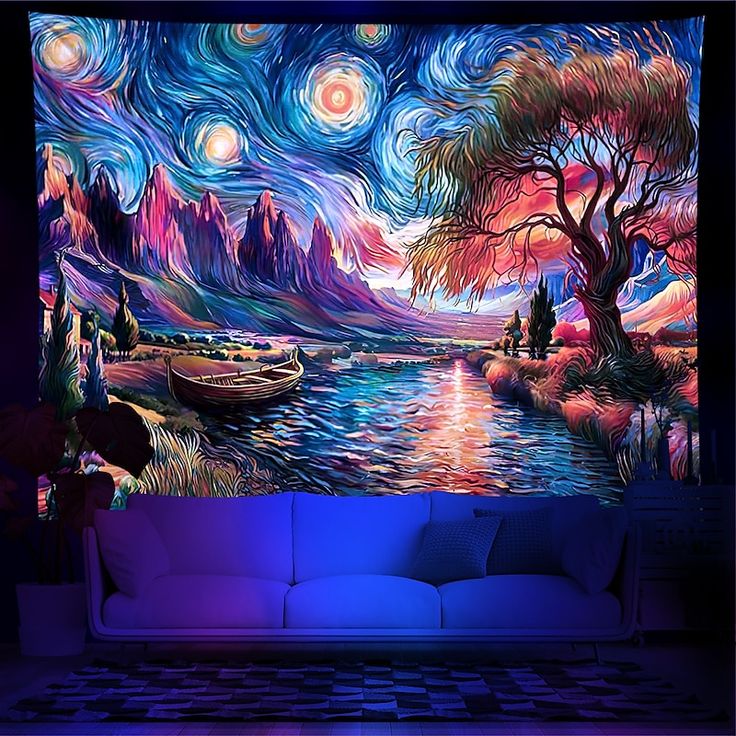 a living room with a painting on the wall and couch in front of it at night