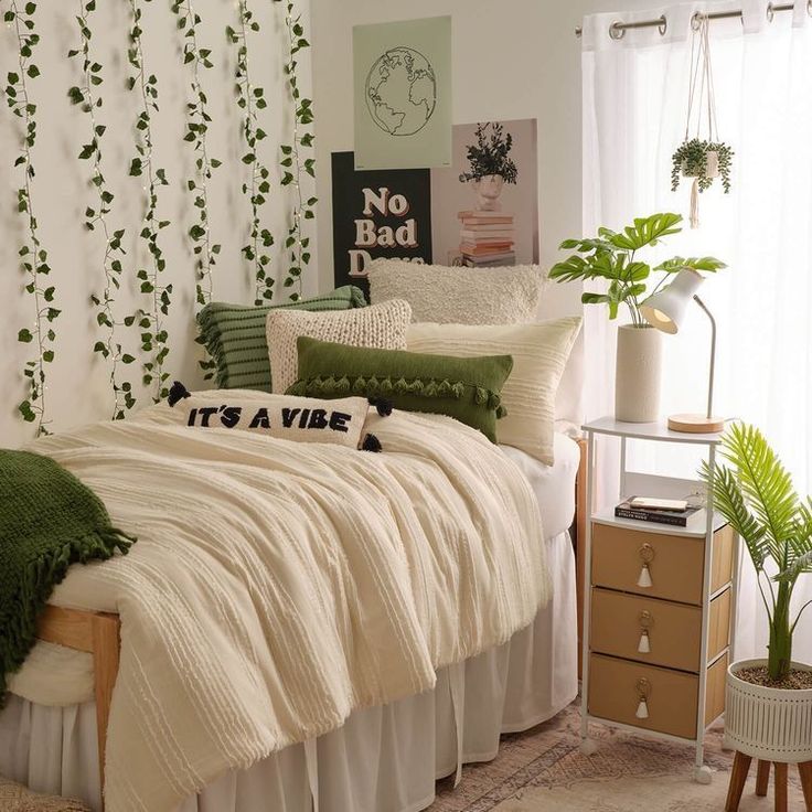 a bedroom with white walls and green plants on the headboard, along with a bed