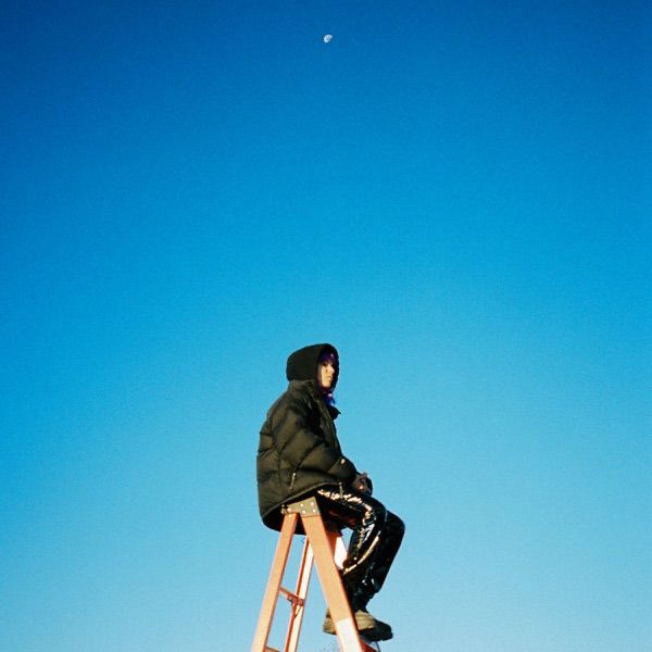 a person sitting on top of a ladder in the sky with a moon behind them