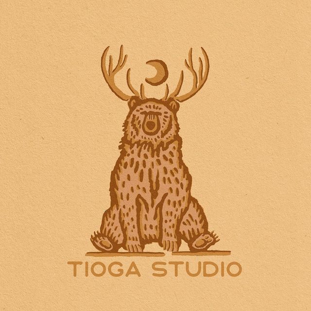 a drawing of a bear with antlers on it's head and the words tioga studio written below