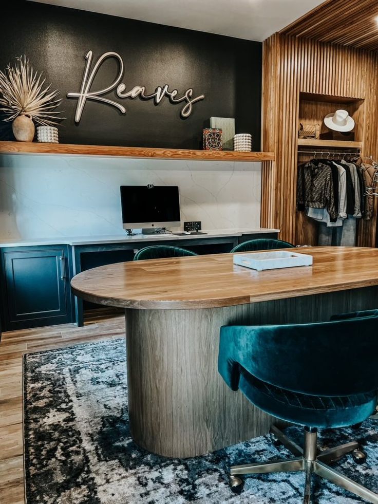 a large wooden table sitting in the middle of a room next to a blue chair