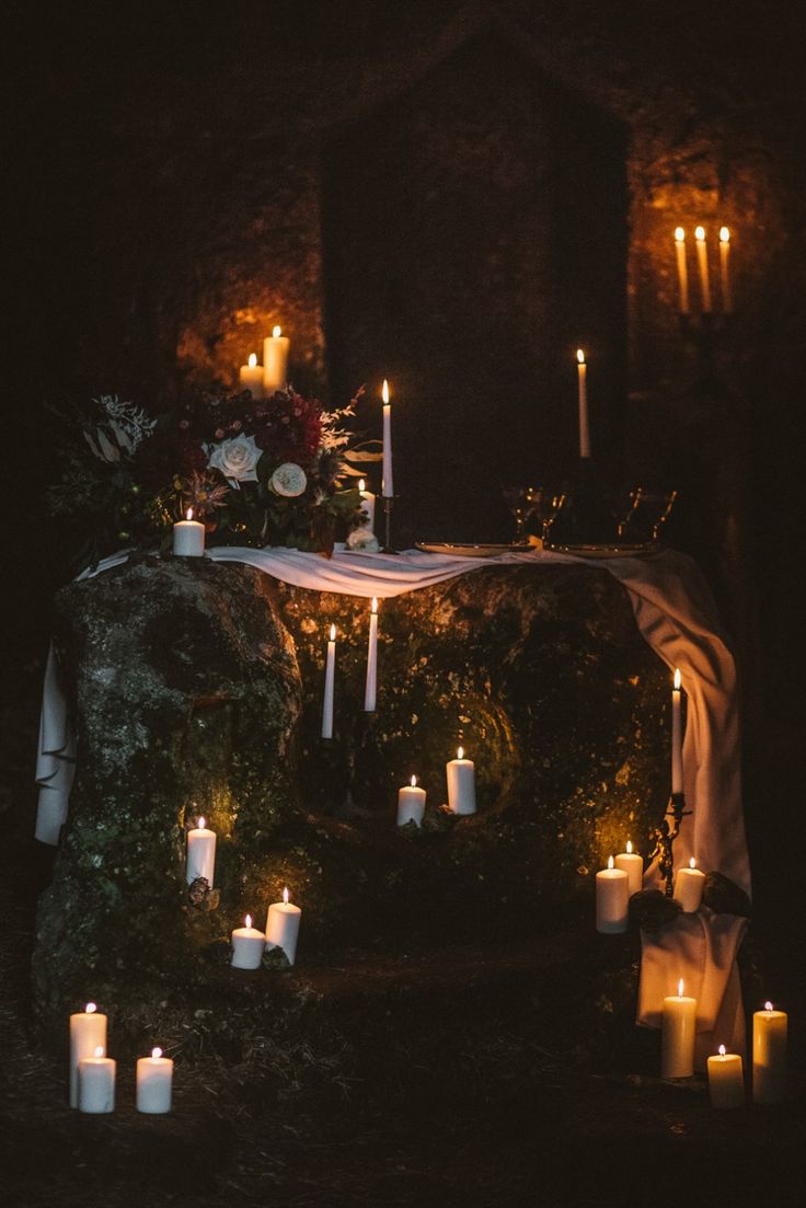 candles are lit in front of an altar