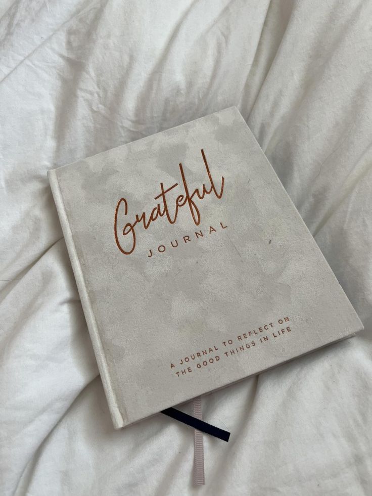 A white gratitude journal on bed , writing book, aesthetic, self care journey, healthy and wellness, good life and lifestyle, fun to use and write. Grateful Journal Aesthetic, Journal Business Aesthetic, Writing Book Aesthetic, Gratitude Journal Aesthetic, Grateful Aesthetic, Gratitude Aesthetic, Cute Notebooks For School, Grateful Journal, Notebook Business