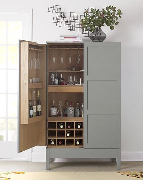 a cabinet with wine glasses and bottles in it