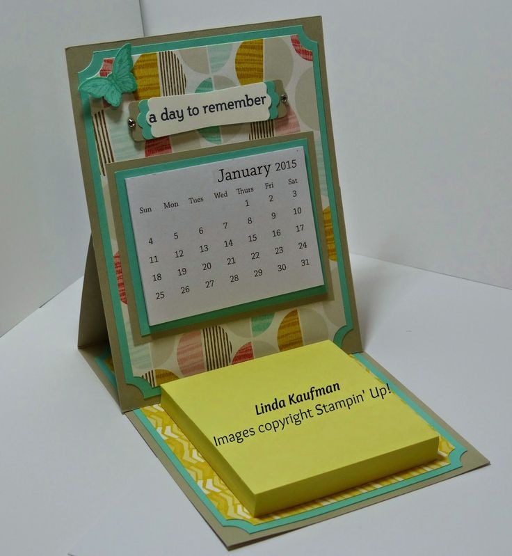 a desk calendar in a card holder on top of a table