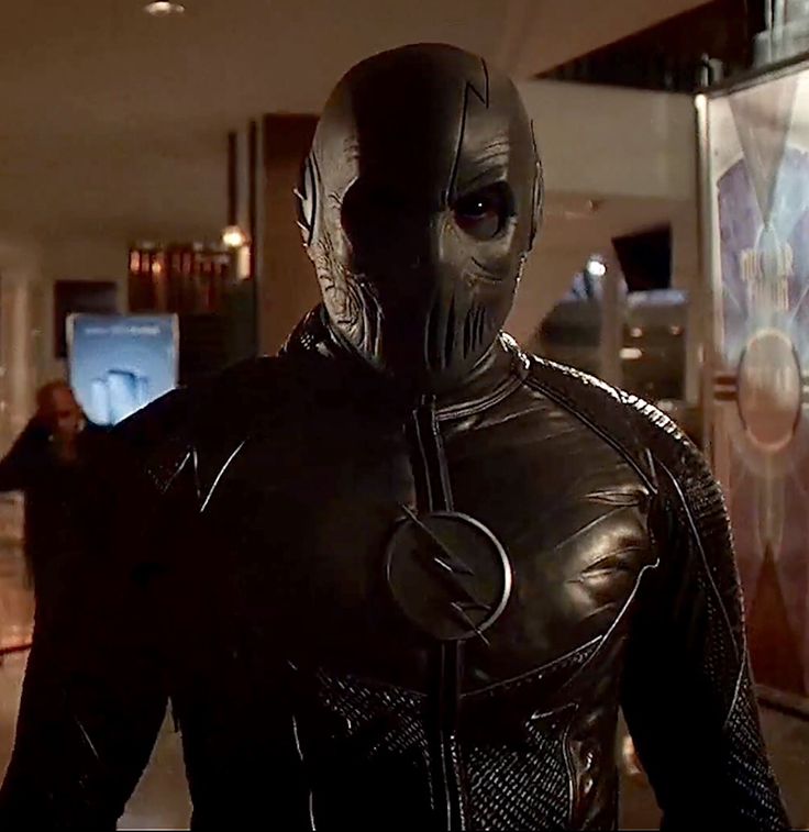 a man in a black leather suit and mask