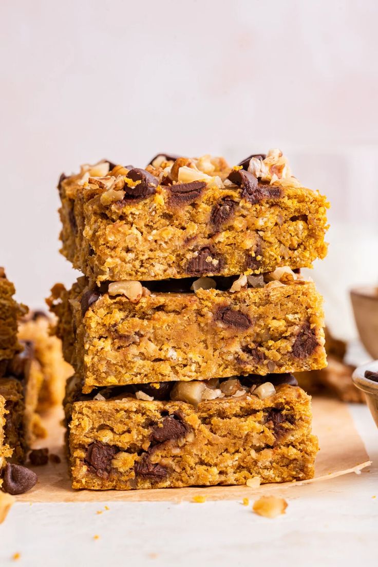 a stack of granola bars sitting on top of a wooden cutting board