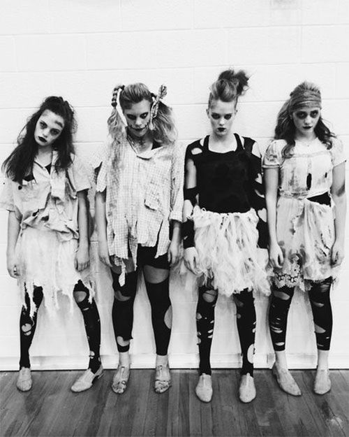 four girls in costumes standing next to each other