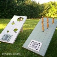 two cornhole game boards sitting in the grass