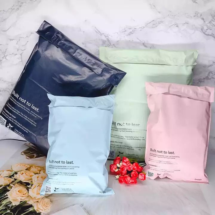 three bags of food sitting on top of a counter next to flowers and other items