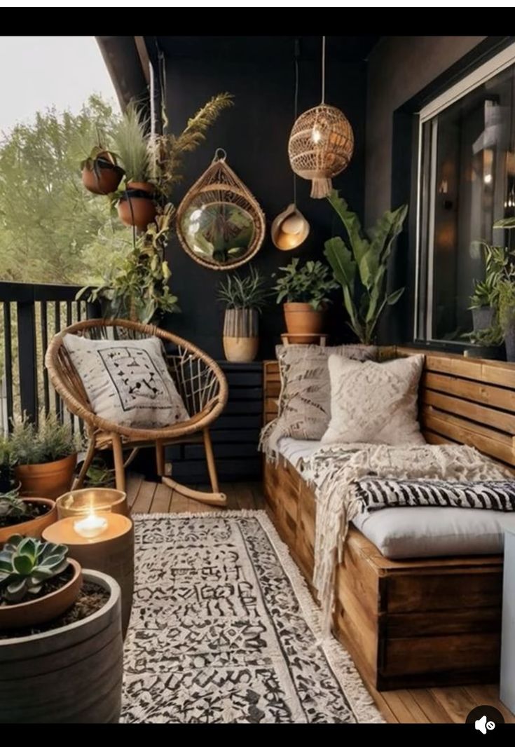 an outdoor patio with plants and potted plants on the deck, along with two wicker chairs