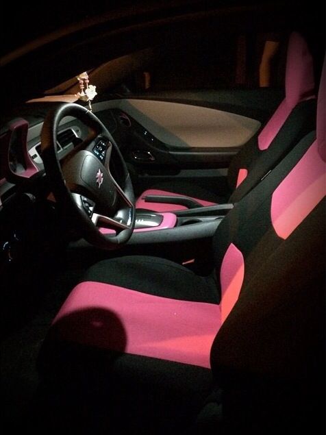 the interior of a car with pink and black seats