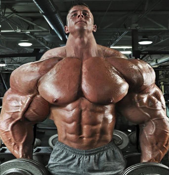 a man standing in front of a barbell with his hands on the dumbs