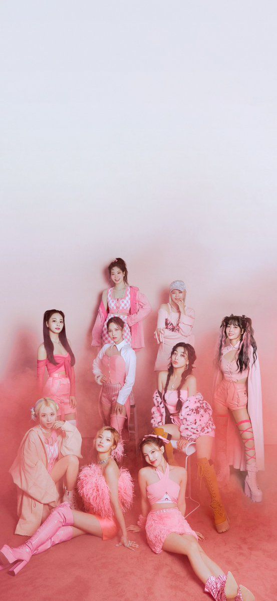 a group of women dressed in pink posing for a photo with one woman sitting on the floor