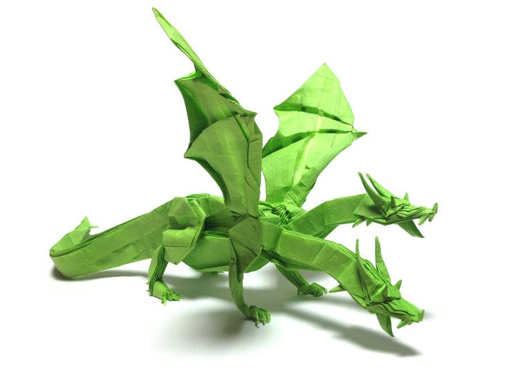 a green origami dragon on a white background