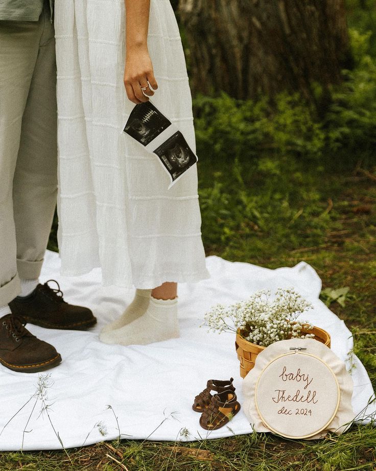 a couple standing next to each other on top of a blanket