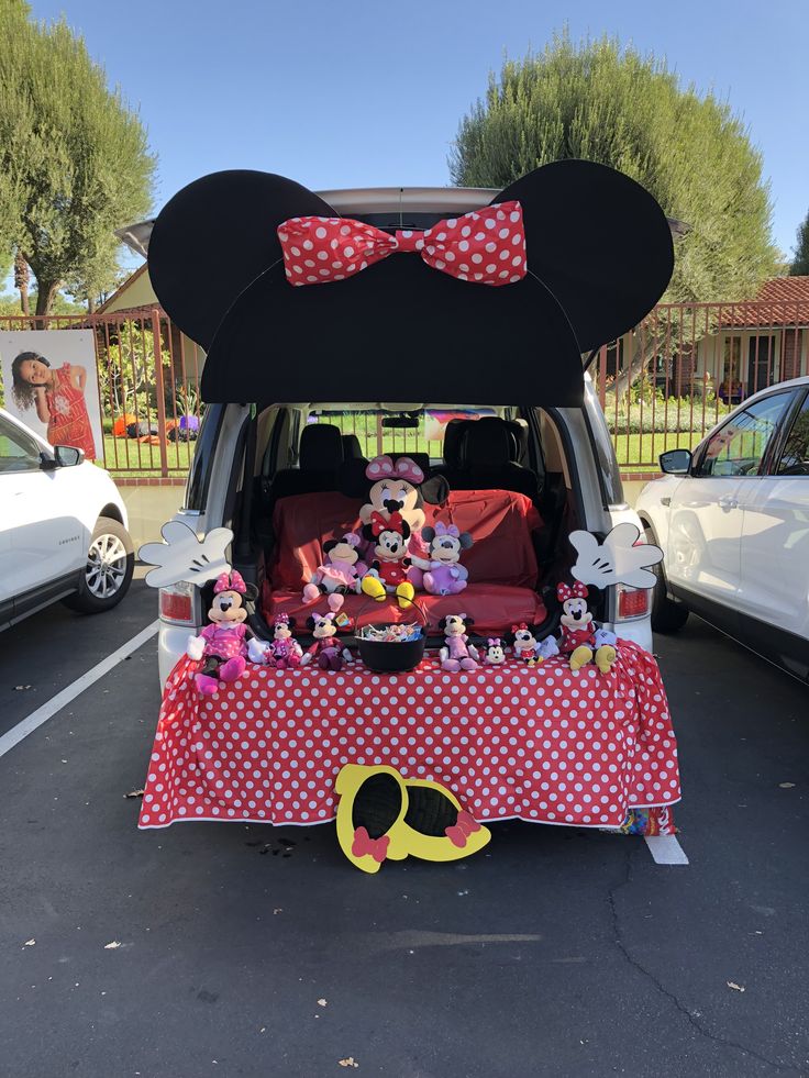 the back end of a van decorated with minnie mouse decorations