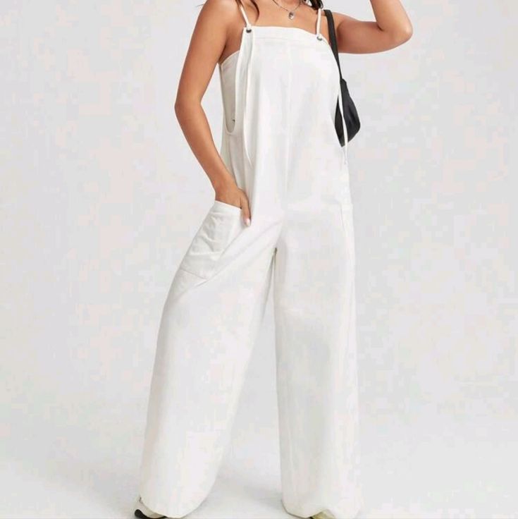 White Pocket Patched Wide Leg Cami Jumpsuit 100% Cotton Casual Wide Leg Jumpsuits And Rompers For Spring, Relaxed Fit Overalls For Spring Vacation, Trendy Solid Color Overalls For Spring, Casual Cotton Overalls For Vacation, Spring Relaxed Fit Overalls For Day Out, Spring Day Out Relaxed Fit Overalls, Casual Relaxed Fit Overalls For Vacation, High Waist Summer Workwear Overalls, Casual White Overall Jumpsuits And Rompers