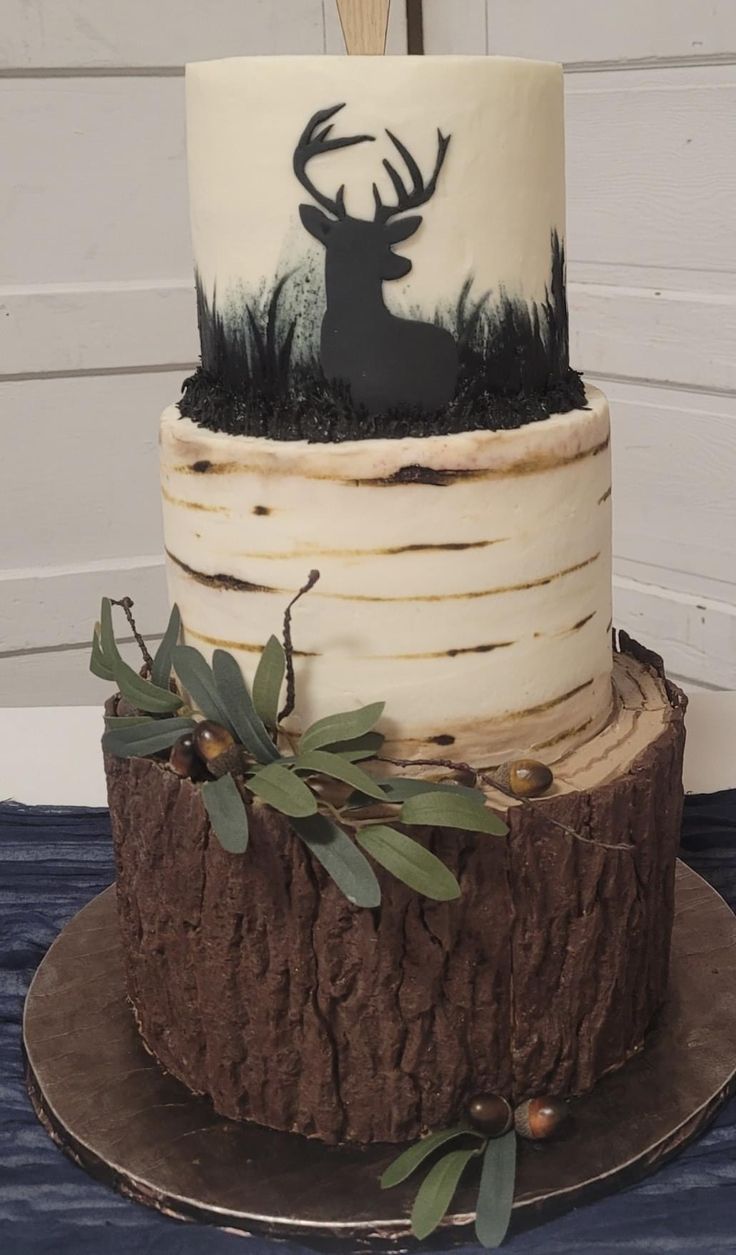 a three tiered cake with an antelope design on it