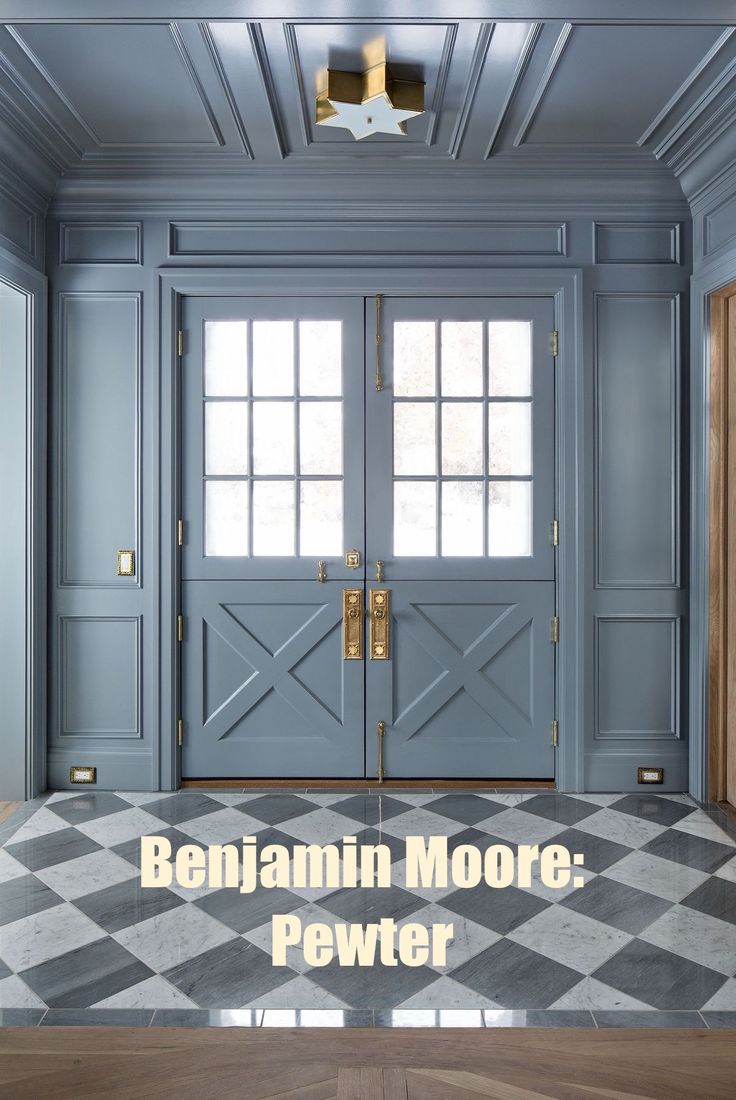 the front door to a house with blue walls and checkered floor