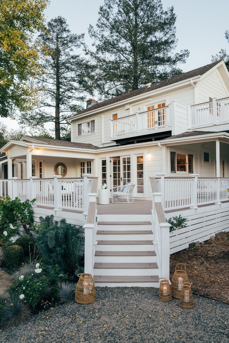 a white house with stairs leading up to it