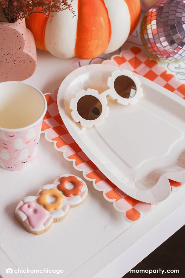 a tray with some cookies and sunglasses on it