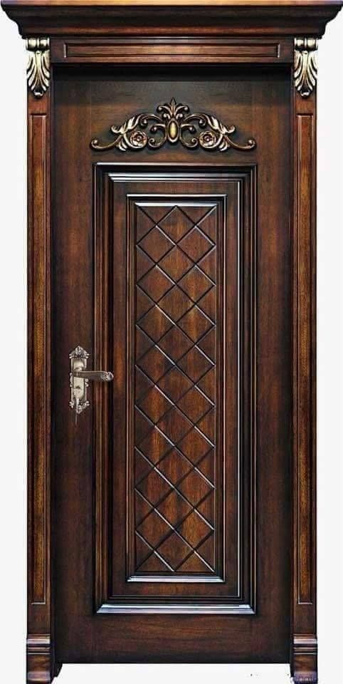 a wooden door with ornate carvings on the front and side panels, in dark wood