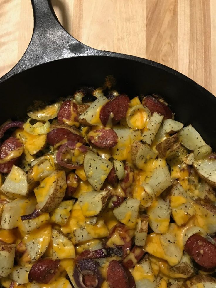 a skillet filled with potatoes and sausage