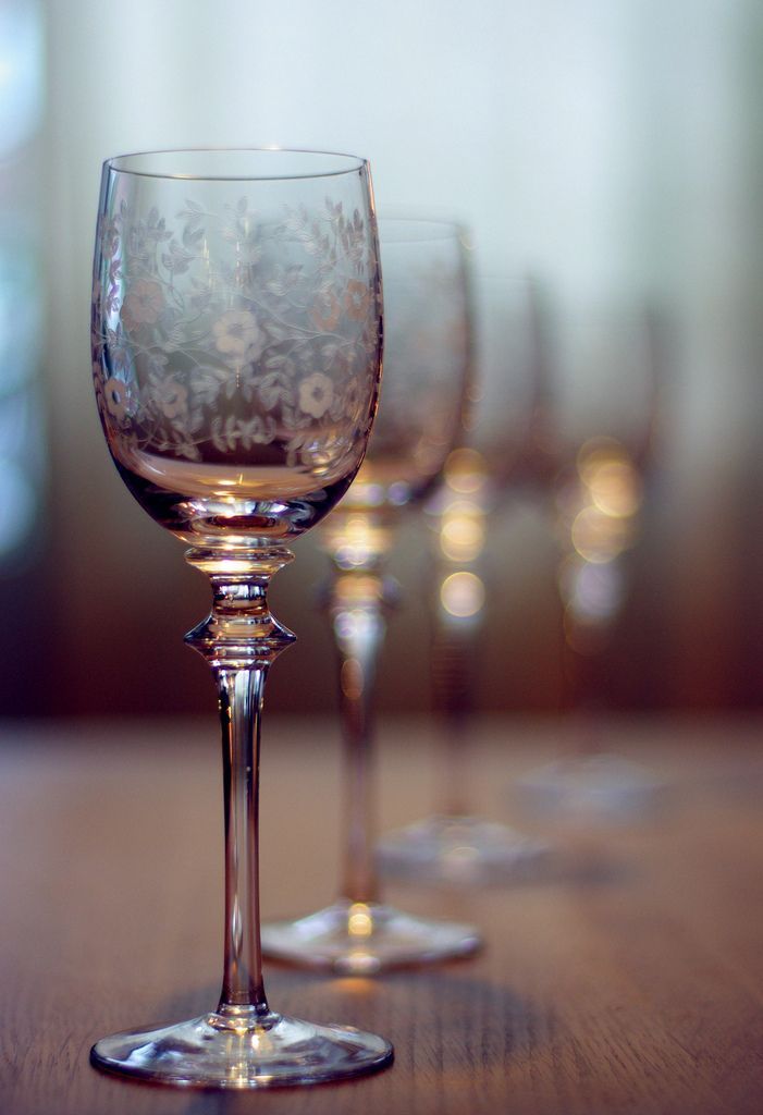 several wine glasses lined up on a table