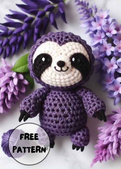 a crocheted stuffed slotty sitting next to purple flowers with the caption free pattern