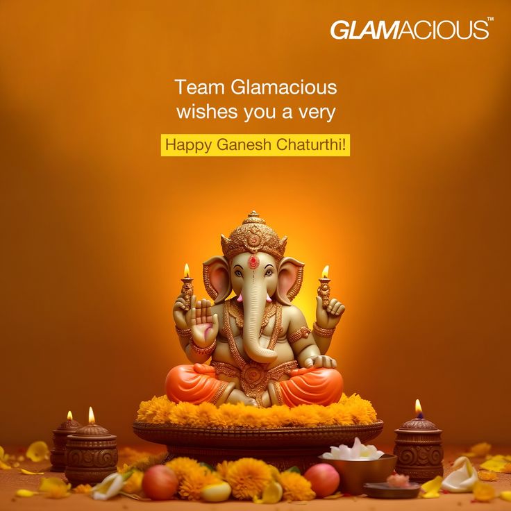 an elephant statue sitting on top of a wooden table next to candles and flowers with the words glamatoous wishes you a very happy ganeshi