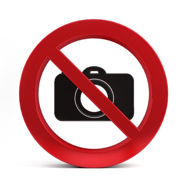 a red circle with a camera in it and a sign that says no photos allowed