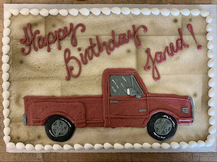 a birthday cake with a red truck on it's side and the words happy birthday yaad