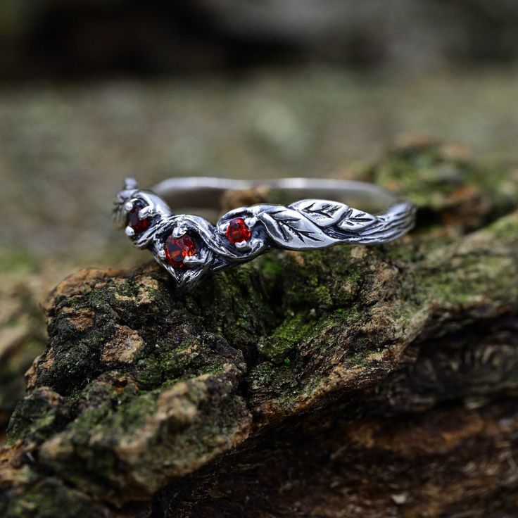 This ring, crafted for women who appreciate the allure of nature, boasts a leafy tree branch band that adds a touch of woodland magic. More than just a ring, it becomes a unique piece of nature-inspired jewelry with a hint of fantasy style.  Characteristics: Metal - Recycled solid sterling silver  Stone - Cubic Zirconia Finish - Oxidized. View all silver forest rings: https://www.etsy.com/shop/TinyShinyJewel?ref=seller-platform-mcnav&section_id=43358995 Care instructions: To care for the ring, avoid contact with water and chemicals such as perfumes and lotions. When the ring is not in use, store it in a dry, cool place to prevent tarnishing. Additional information:  ✦ All rings are made to order. An average turnaround time is 1-5 days. I will make every effort to ship the ring sooner. ✦ FR Forest Promise Ring, Nature Inspired Silver Jewellery, Silver Fantasy Rings For Anniversary, Fantasy Silver Rings For Anniversary, Fantasy Style Silver Ring For Anniversary, Silver Sterling Ruby Ring For Wedding, Magical Sterling Silver Jewelry For Promise, Magical Silver Crystal Ring For Anniversary, Silver Birthstone Crystal Ring For Wedding