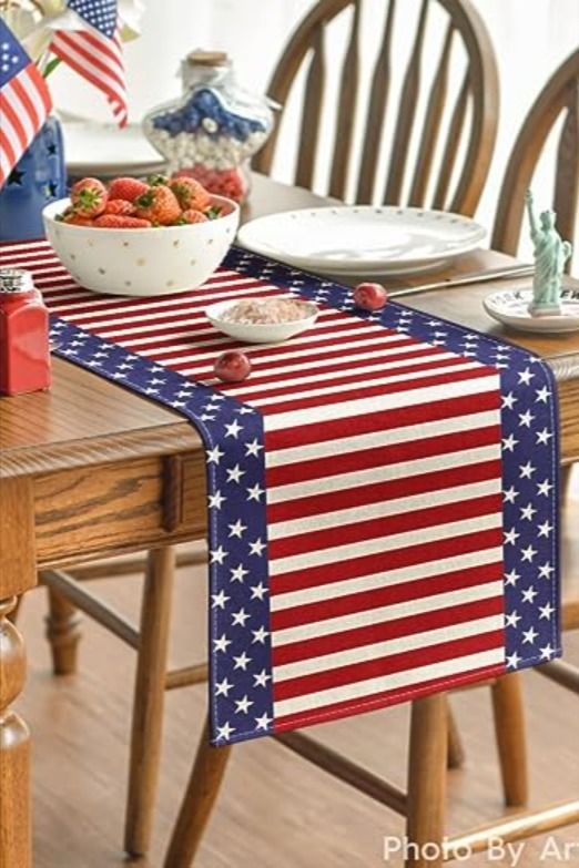 an american flag table runner on a dining room table with plates and bowls of fruit