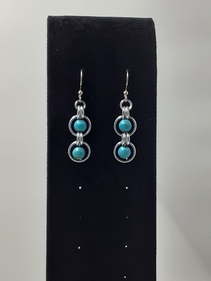 Double loop drop earrings with 6mm reconstituted turquoise bead.  Chainmaille is lightweight and durable.  Made from anodized aluminum, bright aluminum and/or stainless steel, it is easy to wear and care for.  It can range from casual all the way to surprisingly elegant depending on the style, material and weaves used. Earrings Turquoise, Loop Earrings, Anodized Aluminum, Turquoise Earrings, Turquoise Beads, Jewellery Making, Beautiful Earrings, Jewelry Earrings Dangle, Etsy Earrings