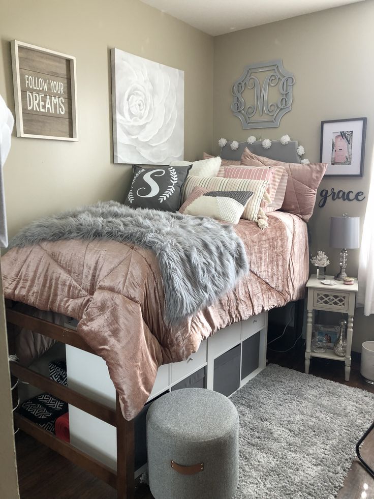 a bedroom with a bed, rugs and pictures on the wall above it is shown