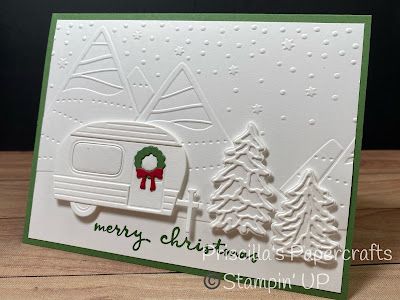 a christmas card with a camper and trees