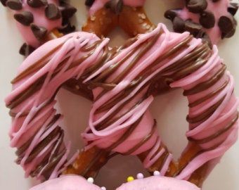 there are many donuts with pink frosting and chocolate sprinkles on them