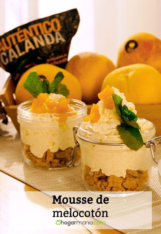 three small jars filled with dessert sitting on top of a table next to oranges