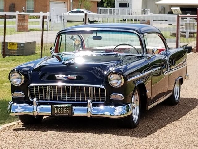 an old car is parked on the side of the road