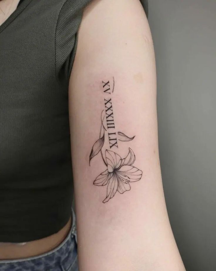 a woman's arm with a tattoo on it that reads, family and flowers