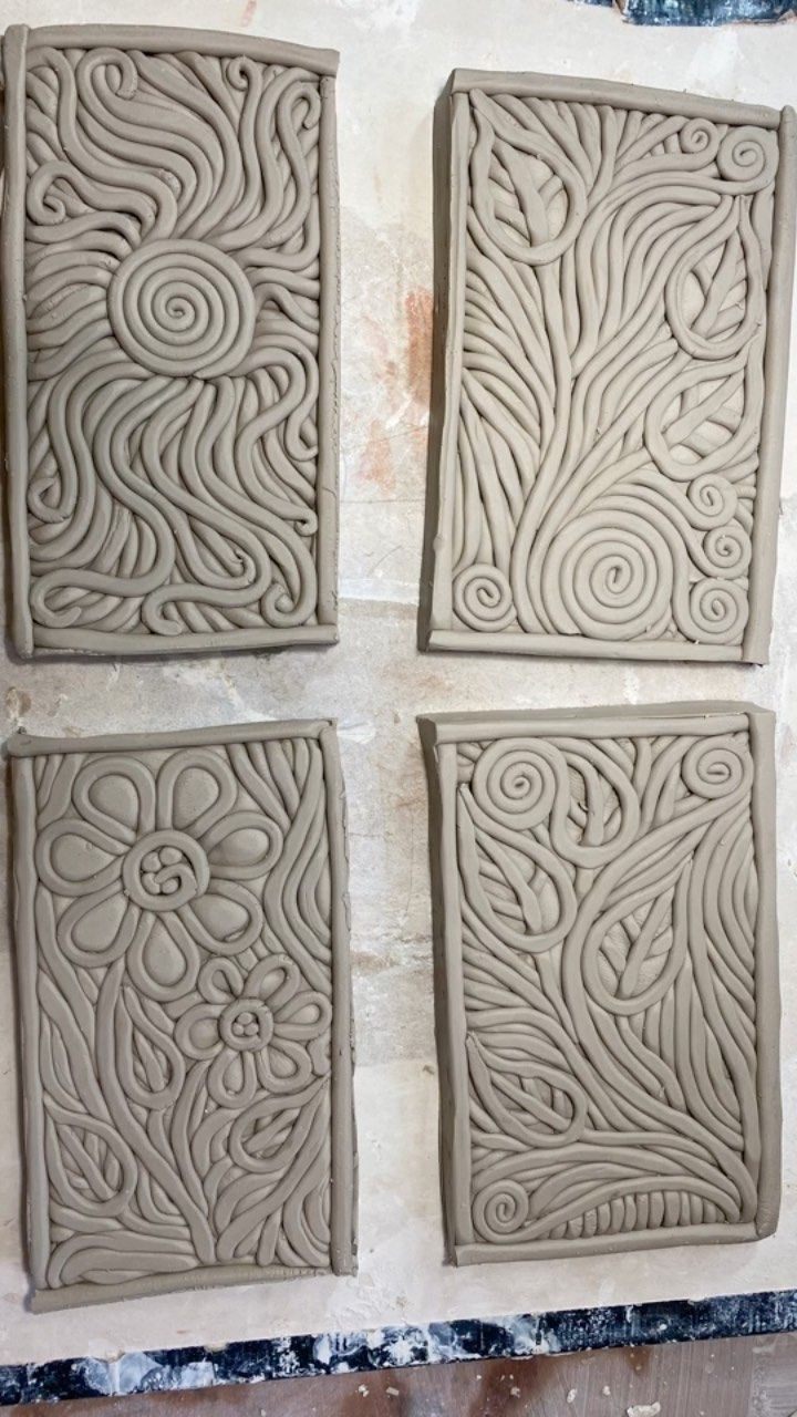 four square tiles are shown in the process of being carved